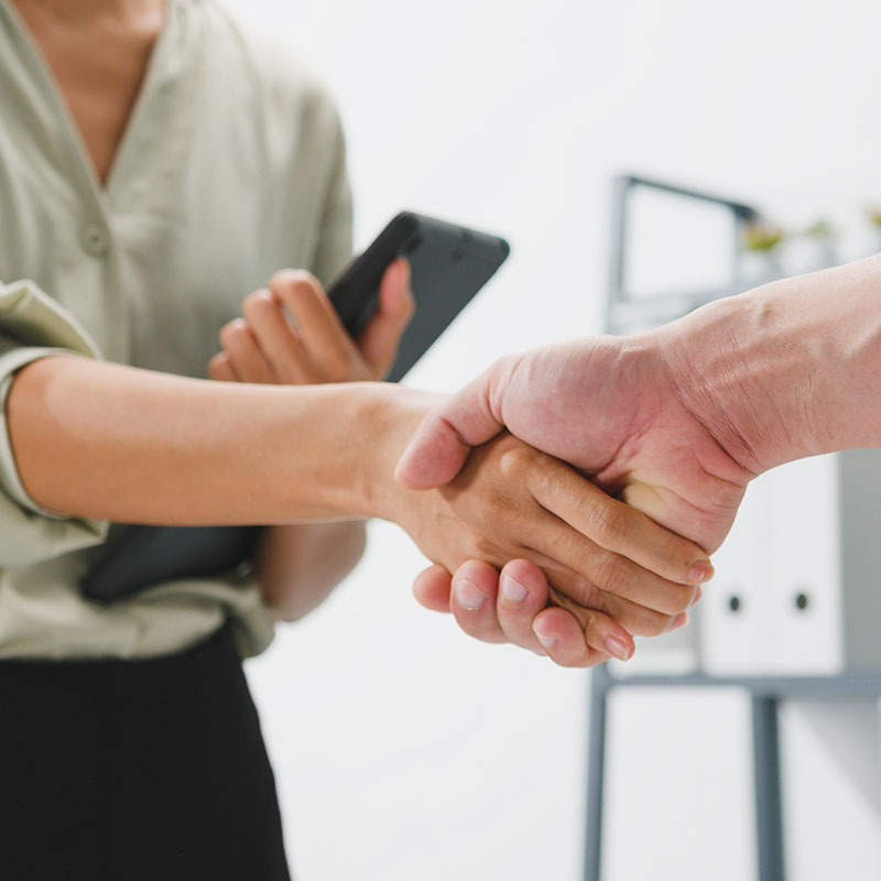 Two people closing a deal with a handshake